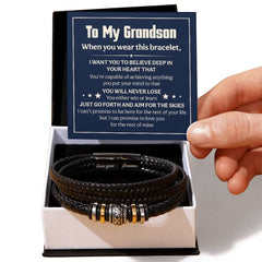 Black braided men's leather bracelet with gold and silver accents displayed in an open gift box, accompanied by a heartfelt message card from grandparent to grandson.