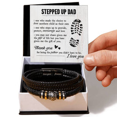 Black braided leather men's bracelet with engraved metal accents inside a gift box, accompanied by a heartfelt message card for a stepdad expressing gratitude and love.