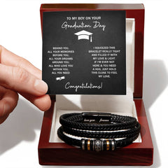Handcrafted black leather bracelet with engraved metal accents displayed in a polished wooden gift box, accompanied by a sentimental graduation message card.