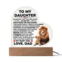 Heart-shaped acrylic plaque on a wooden base with a heartfelt message from a father to his daughter, featuring illustrations of a lion and lion cub, ideal as a sentimental gift.
