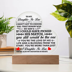 Heart-shaped acrylic plaque with a heartfelt message for a daughter-in-law, displayed on a wooden base, ideal as a sentimental gift or home décor.