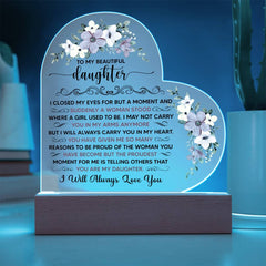 Heart-shaped LED acrylic plaque with floral accents and a heartfelt message from parents to their daughter, illuminated on a wooden base for home décor.