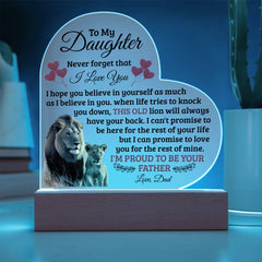 Heart-shaped acrylic plaque with a heartfelt message from a father to daughter, featuring an image of a lion and lion cub, illuminated on a wooden base.