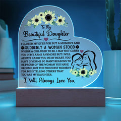 Heart-shaped acrylic plaque with a heartfelt message to a daughter, illuminated on a wooden base, featuring floral designs and an outline of a mother and daughter.