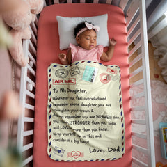 Sleeping baby girl wrapped in a soft personalized sherpa fleece blanket with an inspirational father’s message, lying peacefully in a pink crib with plush toys nearby.