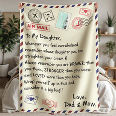 Cozy sherpa fleece blanket designed like an airmail letter with an encouraging message from parents to their daughter, featuring decorative stamps and heartfelt text.