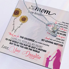Heart-shaped silver necklace with a sparkling crystal centerpiece, displayed on a sentimental card expressing love and gratitude from a daughter to her mother.