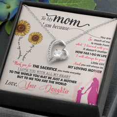 Silver heart-shaped necklace with a central clear crystal, displayed on a sentimental message card expressing love and gratitude from a daughter to her mother, featuring sunflower illustrations.