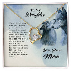 Gift box featuring a gold heart-shaped pendant necklace with a central gemstone, displayed on a card with a touching message from mom to daughter and an illustration of two wolves, for the Old Wolf - Forever Love Necklace.