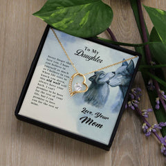 Old Wolf - Forever Love Necklace featuring a gold heart pendant with a clear stone, displayed in a gift box with a sentimental message from Mom to Daughter and wolf artwork.