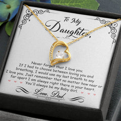 Gold heart-shaped necklace with a sparkling crystal centerpiece displayed on a decorative card featuring a sentimental message from a father to his daughter.
