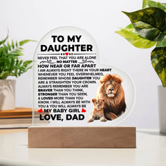 A heart-shaped acrylic plaque on a wooden base featuring a heartfelt message from a father to his daughter, decorated with images of a lion and lion cub.