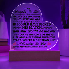 Heart-shaped acrylic plaque with a heartfelt message for a daughter-in-law, illuminated by a wooden base with soft purple LED lighting, perfect as a sentimental gift.