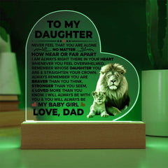 Heart-shaped acrylic plaque with a heartfelt message from a father to his daughter, illuminated on a wooden base, featuring an image of a lion and cub.