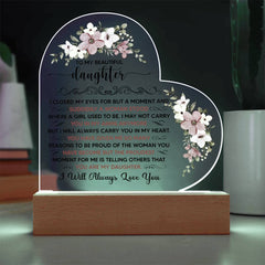Heart-shaped LED acrylic plaque with floral accents and a heartfelt message from a parent to their daughter, illuminated on a wooden base.