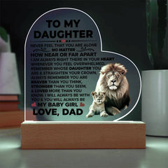 Heart-shaped acrylic plaque with an inspirational message from a father to his daughter, featuring a lion and cub illustration, displayed on a wooden base with LED lighting.