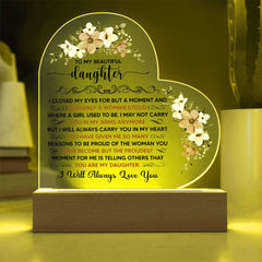 Heart-shaped LED acrylic plaque with floral designs and a heartfelt message from a parent to their daughter, illuminated and displayed on a wooden base.