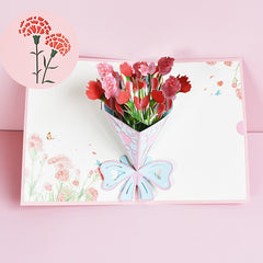 Open 3D pop-up greeting card featuring a vibrant bouquet of pink and red carnation flowers with a pastel blue bow on a light floral background, perfect for Mother's Day or heartfelt occasions.