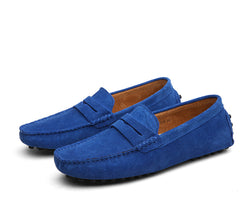 Pair of men's genuine suede slip-on loafers in vibrant blue with classic penny strap detailing, ideal for casual and formal wear.