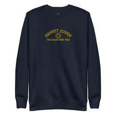 Navy fleece sweatshirt with yellow "Sunset Lover" and "The Good Vibe Ride" text featuring a sun graphic, designed for beach and ocean lovers.