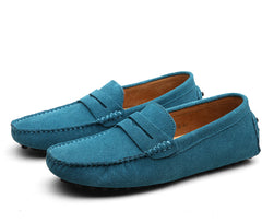 Pair of men's genuine suede penny loafers in blue, classic slip-on driving shoes designed for casual and formal wear with detailed stitching and comfortable lining.