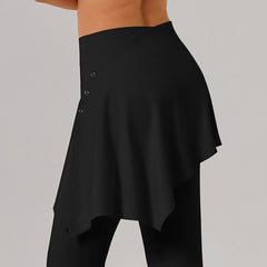 Close-up of a person wearing black high-waisted yoga pants with a layered asymmetrical skirt detail, showcasing a comfortable and stylish fitness outfit.