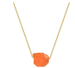Delicate gold chain necklace featuring a raw orange crystal pendant with a natural, organic shape for a minimalist boho look.