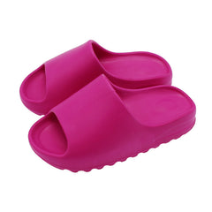 Pair of vibrant pink platform slides made from lightweight, durable material with a contoured sole designed for comfort and casual outdoor wear.