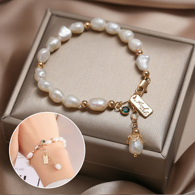 Elegant white pearl bracelet with gold accents and a personalized charm, displayed on a luxurious gift box, perfect for anniversary or heartfelt gifts.