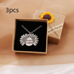 Silver sunflower locket necklace with a hidden message engraved inside, displayed in a gift box decorated with a small sunflower and a "specially for you" tag.