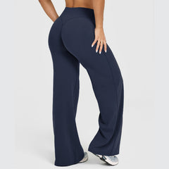 Rear view of a person wearing ultra-soft high-waisted straight leg yoga pants in navy blue, paired with white sneakers, showcasing comfortable fitness and lounge wear.